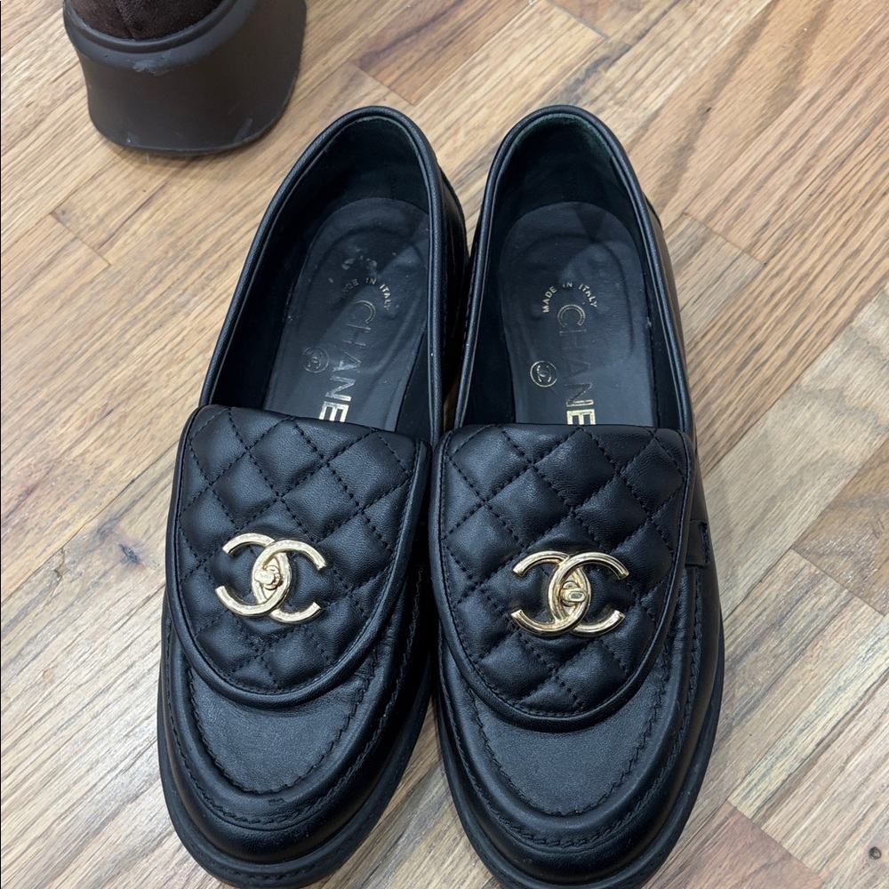 CHANEL Black Quilted Loafers with Gold Emblem